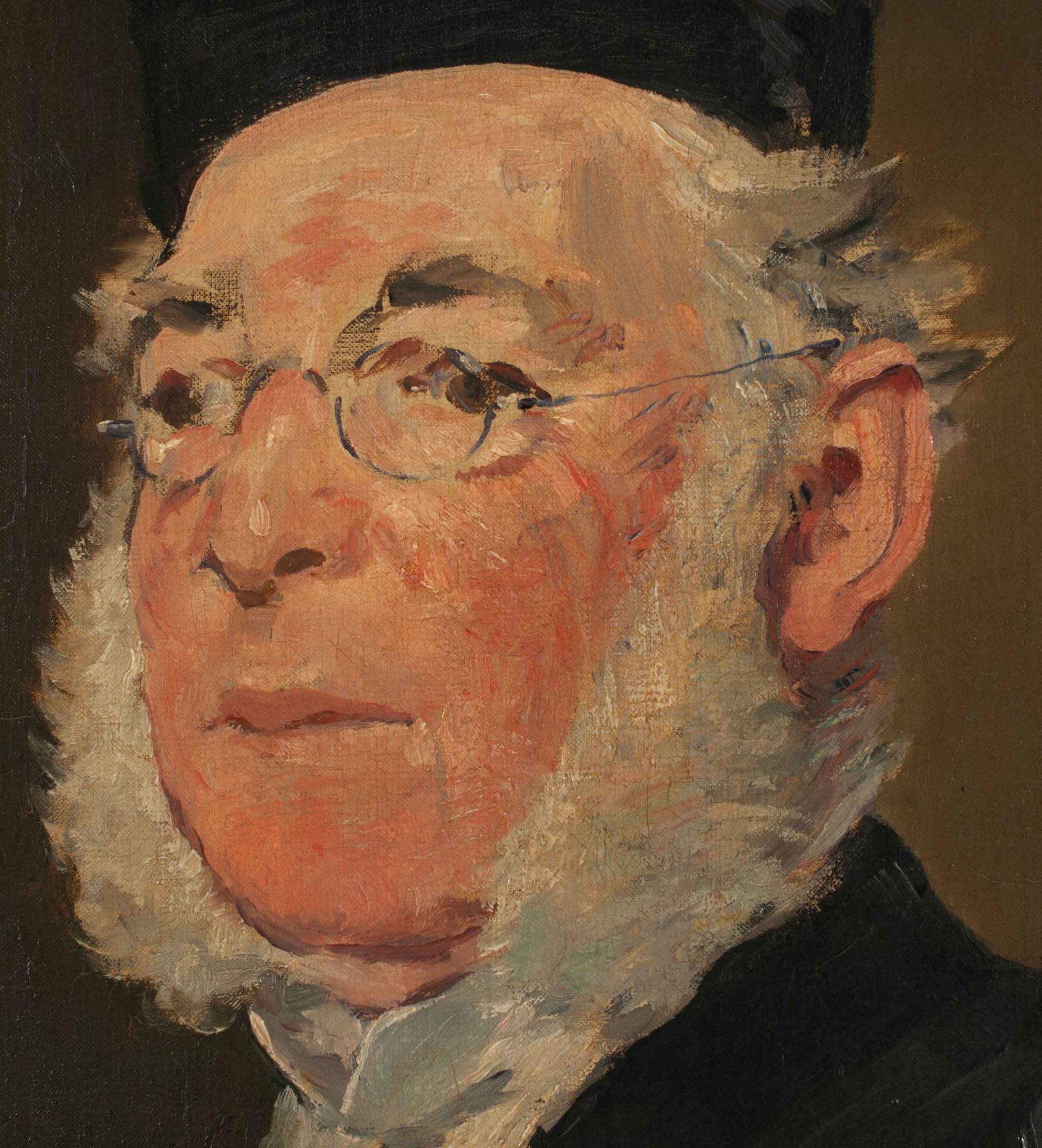 A bespectacled old white man with facial hair.
