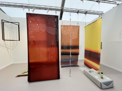 Large photographic films that are hung from the ceiling; they hang freestanding in a fair booth.
