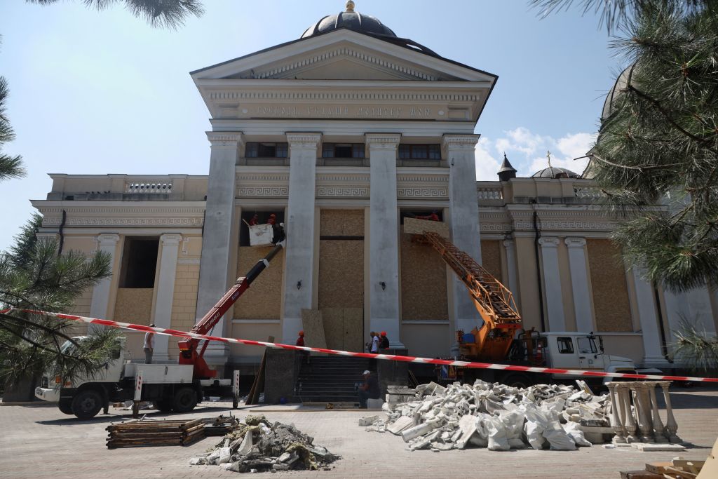TOPSHOT - Cranes and workers board up the windows of the Transfiguration Cathedral damaged as a result of a missile strike in Odesa on July 23, prior to a service on July 24, 2023, amid the Russian invasion of Ukraine. Ukraine on Sunday said 19 people, including four children, were wounded in a Russian overnight missile attack on Odesa that also killed one person. (Photo by Oleksandr GIMANOV / AFP) (Photo by OLEKSANDR GIMANOV/AFP via Getty Images)