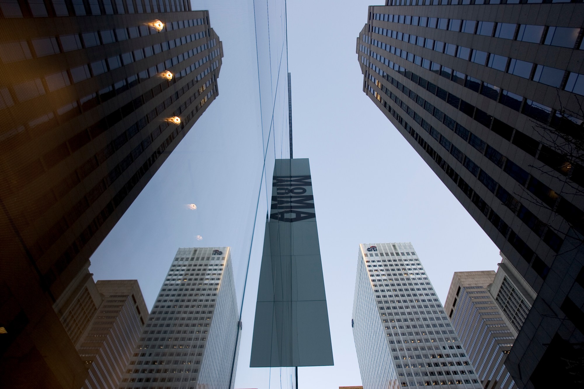 The glass facade of the newly expanded and renovated Museum of Modern Art, reflects the surrounding buildings. The new MoMA, designed by architect Yoshio Tanigchi, is twice as large as before and cost $425 million to be built. (Photo by James Leynse/Corbis via Getty Images)