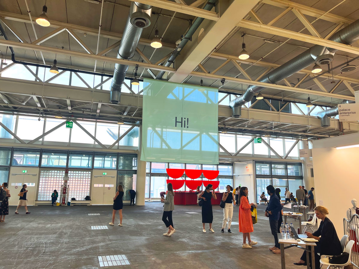 View of an art fair with a sign that reads 'Hi!'