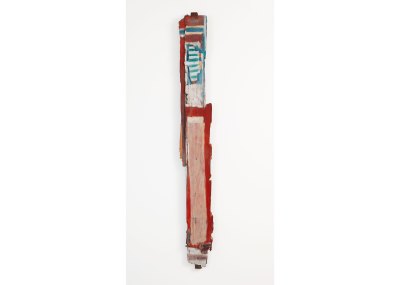 A sculpture made of a piece of scrap wood that has been painted.